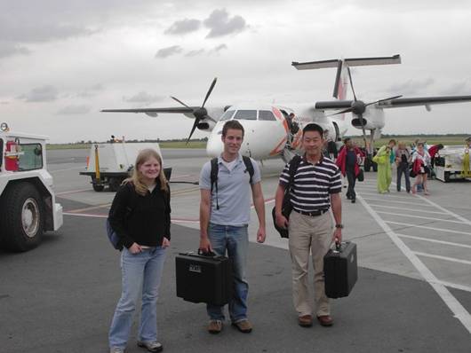 Fig. 1: Erica Gralla, Matt Silver and Mike Li in front of the Bombardier turboprop. Matt and Mike are holding the black suitcases with RFID equipment
